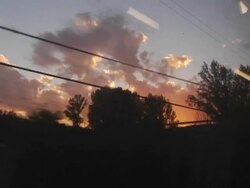 POV, Spain, Silhouetted trees and power cables against colorful dusk sky from moving train Stock Footage
