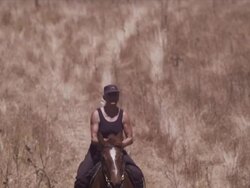 Long lens close shot, Karen runs horse down hill towards camera Stock Footage
