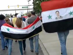 Demonstrators march with Syrian flag against war. Stock Footage
