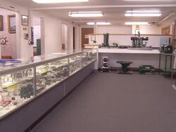 WS PAN across showroom of Covington Engineering machine tool manufacturing plant displaying products on shelves / Redlands, California, USA Stock Footage