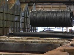 Steel Mill - Coils lifted from bath Stock Footage
