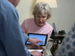 Seniors Discuss Financial Issues Using Tablet Computer Stock Footage