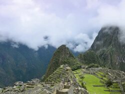 WS T/L HA View of tourist at Machu Picchu and clouds low over mountains / Machu Picchu, Peru Stock Footage