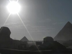 WS, Sun shining above silhouettes of Pyramids and Sphinx, Giza, Egypt Stock Footage
