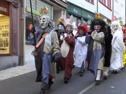 MS Shot of masked people walking on street and celebrating in Basel Carnival (Basler Fasnacht) / Basel, Switzerland Stock Footage