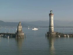 WS View of Lindau harbour entrance and ferry with lighthouse at Lake Constance / Lindau, Bavaria, Germany  Stock Footage