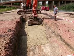 MS Shot of excavator leveling material in pit at bridge construction site at Saar river, Wiltingen, Germany / Wiltingen, Rhineland Palatinate, Germany Stock Footage
