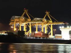 Cargo ship loading at night Stock Footage