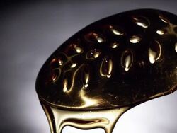 Syrup over Metal Spoon Stock Footage