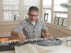 Mixed race man playing keyboard Stock Footage