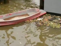 Water pollution in river with boat Stock Footage