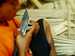 CU SLO MO Shot of man using broad knife for trimming wood of machete handle / Muang Ngoi, Luang Prabang, Laos Stock Footage
