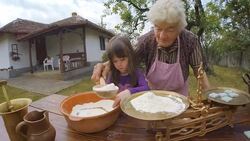 Cooking With Grandma-Beautiful Little Girl Learns How To Make Cookies  in The Bright-lit Vintage Kitchen Stock Footage