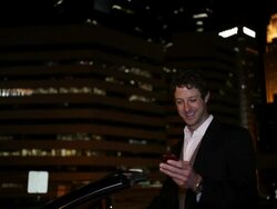 MS TD Well dressed young man using  cell phone and smiling next to his car at night in urban area / Minneapolis, Minnesota, United States Stock Footage