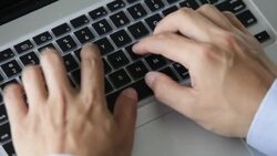 Hands type on a laptop keyboard. Stock Footage