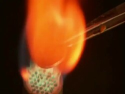 British penny held by tweezers in flame of bunsen burner, with audio, sound available Stock Footage