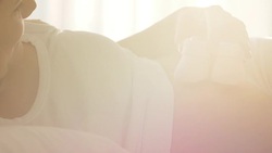 Pregnant woman holding baby shoes on tummy Stock Footage