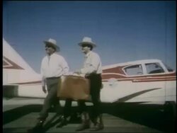 1964 PAN 2 men in cowboy hats with luggage walk from airplane past World's Fair sign / NY Stock Footage