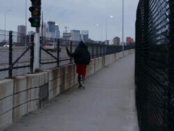 MS Young man in sweatshirt walking from near  freeway after working out and exercising  / Minneapolis, Minnesota, United States Stock Footage