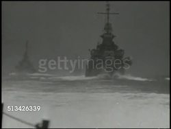1944: BATTLE OF SAIPAN: VS U.S. Navy transport ships moving on the Pacific Ocean. INT VS Operators checking maps. EXT VS Scout airplanes launching from ramp on deck of naval ship. World War II, WWII, Pacific Front Instructional Video