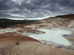 MS Boiling hot geothermal water in small water pool with steams and orange rock in background / Krafla, Myvatn region, Iceland Stock Footage