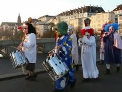 MS PAN Shot of people with mask and dressing up celebrating Basler Fasnacht (Basel Carnival) on street / Basel, Switzerland Stock Footage