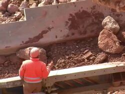 MS Man removing metal from chrushing machine at quarry / Taben-Rodt, Rhineland-Palatinate, Germany Stock Footage