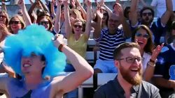 MS TS Crowd of football fans sitting in stadium cheering during game Stock Footage