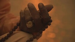 C/U hand of a sadhu w/ prayer beads in the Ganges river Stock Footage