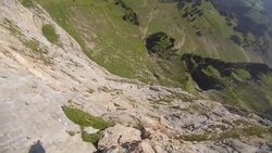 POV slow motion wingsuit flying down cliff face Stock Footage