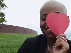 MS Young girl smiling and having fun while putting paper heart in front of her face outside in park on sunny day / Minneapolis, Minnesota, United States Stock Footage