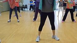 Young female instructor leads yoga class for seniors Stock Footage