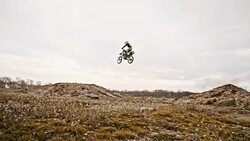 SLO MO Stunt biker jumping over dirt ramp Stock Footage