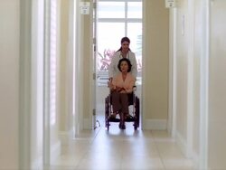 MS PAN View of female patient in escorting into medical facility / Miami, FLORIDA, USA Stock Footage