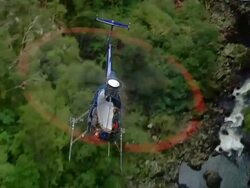 AIR TO AIR, Helicopter flying above forest and mountain river, Fiordland National Park, New Zealand Stock Footage