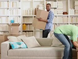 Family moving boxes and sitting on sofa Stock Footage