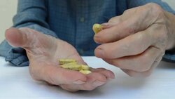 Senior adult holding a medicine pill in his hands. Stock Footage
