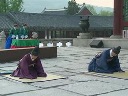  MS People wearing traditional uniform bowing in revial event of joseon dynasty at gyeongbokgung royal palace AUDIO / Seoul, South Korea Stock Footage