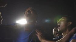 A goaltender crouches in disappointment while the opposing team celebrates their win. Stock Footage