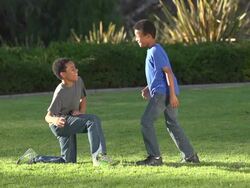 Two brothers giving each other a high five after kicking a football.  - Super Slow Motion - filmed at 240 fps Stock Footage