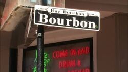 A sign identifies Bourbon Street in the French Quarter of New Orleans. Stock Footage