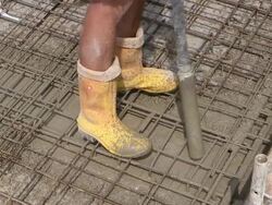CU Shot of cement compressor removing air from filled casting concrete at house construction, building site / Hermeskeil, Rhineland Palatinate, Germany Stock Footage