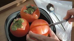 tasty ripe persimmons on a plate Stock Footage