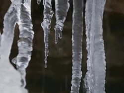 CU TU Icycles slowly melting and dripping on frozen websters falls  / Dundas, Ontario, Canada    Stock Footage