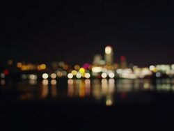 Lights of downtown Omaha at night with Missouri river in foreground cityscape Stock Footage