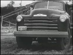 Montage: 1950 Chevy truck loading, spreading lime Stock Footage