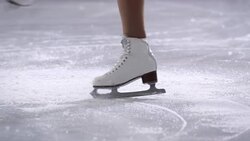 SLO MO TS Female figure skates in a crossfoot spin Stock Footage