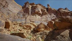 Wide low angle panning shot of rocks in desert landscape / Moab, Utah, United States Stock Footage