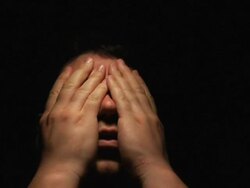 frustrated man shadowed face on black background Stock Footage