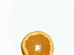 MS SLO MO Slice orange being Fallen into glass of orange / Vieux Pont, Normandy,  France Stock Footage